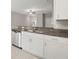 Well-equipped kitchen with granite counters, stainless appliances, and bright white cabinets at 9716 Mulberry Marsh Ln, Sun City Center, FL 33573