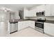 Modern kitchen featuring stainless steel appliances, white cabinets, and granite countertops at 9716 Mulberry Marsh Ln, Sun City Center, FL 33573