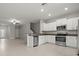 Open kitchen featuring stainless steel appliances, granite countertops, and white cabinetry at 9716 Mulberry Marsh Ln, Sun City Center, FL 33573