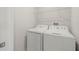 Bright laundry room features a white washer and dryer at 9716 Mulberry Marsh Ln, Sun City Center, FL 33573