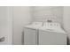 Clean and functional laundry room with modern washer and dryer at 9716 Mulberry Marsh Ln, Sun City Center, FL 33573