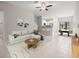 Bright living room with a large sofa, open to the kitchen, and tile floors at 9716 Mulberry Marsh Ln, Sun City Center, FL 33573