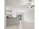 Clean living space features neutral walls, tile floors, and views into the kitchen at 9716 Mulberry Marsh Ln, Sun City Center, FL 33573