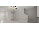 Open living room features tile floors, neutral walls, and a ceiling fan at 9716 Mulberry Marsh Ln, Sun City Center, FL 33573