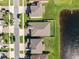 This aerial view shows the neighborhood, house, and lake at 11717 Navajo Sandstone St, Riverview, FL 33579