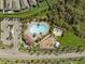 An aerial view shows a community pool, basketball court, playground, parking, and surrounding homes at 11717 Navajo Sandstone St, Riverview, FL 33579