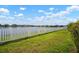 This backyard features a white picket fence and a lovely lake at 11717 Navajo Sandstone St, Riverview, FL 33579