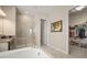 Luxurious bathroom with a soaking tub, glass shower, and access to a walk-in closet at 11717 Navajo Sandstone St, Riverview, FL 33579