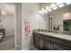 Bathroom featuring double vanity, granite counters, and modern fixtures at 11717 Navajo Sandstone St, Riverview, FL 33579