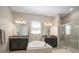 Modern bathroom featuring a soaking tub, separate glass shower, and and sinks at 11717 Navajo Sandstone St, Riverview, FL 33579