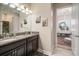 Modern bathroom featuring double vanity with granite counters and decor at 11717 Navajo Sandstone St, Riverview, FL 33579