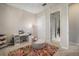 Bright bedroom features a sewing machine, a comfortable chair, and access to a walk-in closet at 11717 Navajo Sandstone St, Riverview, FL 33579