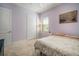 Comfortable bedroom with a floral bedspread, soft lighting, and a view from the window at 11717 Navajo Sandstone St, Riverview, FL 33579