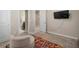 Bright bedroom featuring a cozy sitting area with a colorful accent rug and mounted TV at 11717 Navajo Sandstone St, Riverview, FL 33579
