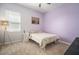 Cozy bedroom featuring a full bed, nightstand, and window with blinds at 11717 Navajo Sandstone St, Riverview, FL 33579