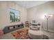 Well-lit bedroom featuring a sewing machine, a printer, and a comfortable, cozy chair at 11717 Navajo Sandstone St, Riverview, FL 33579