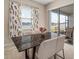 A stylish dining table and chairs are situated near sliding glass doors and overlook the lake at 11717 Navajo Sandstone St, Riverview, FL 33579