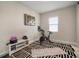 A minimalist exercise room with a black-and-white striped rug and a stationary bike at 11717 Navajo Sandstone St, Riverview, FL 33579