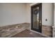 A welcoming front porch with a decorative wreath on the glass front door and stone accents at 11717 Navajo Sandstone St, Riverview, FL 33579