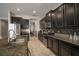 Kitchen features granite countertops, dark cabinets, and an open layout at 11717 Navajo Sandstone St, Riverview, FL 33579