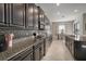Modern kitchen featuring granite countertops, stainless steel appliances, and sleek dark cabinetry at 11717 Navajo Sandstone St, Riverview, FL 33579
