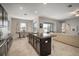 Open kitchen with island, granite counters, stainless appliances, and easy access to living area at 11717 Navajo Sandstone St, Riverview, FL 33579
