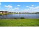 Scenic view of a pond surrounded by lush green grass and neighboring houses, perfect for relaxation at 11717 Navajo Sandstone St, Riverview, FL 33579
