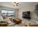 Relaxing living room with a large sectional couch and sliding glass doors leading to the lanai at 11717 Navajo Sandstone St, Riverview, FL 33579