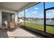 Covered screened patio with comfortable seating and peaceful water views, ideal for relaxation at 11717 Navajo Sandstone St, Riverview, FL 33579