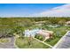 Aerial view featuring the community pool with the lounge chairs and palm trees at 1701 Pinehurst Rd # 27D, Dunedin, FL 34698