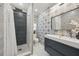 Modern bathroom with decorative tile, vanity with undermount sink, and glass-enclosed shower at 2301 46Th S St, St Petersburg, FL 33711