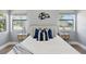 Inviting bedroom featuring large windows, neutral colors, stylish decor, and bedside tables with lamps at 2301 46Th S St, St Petersburg, FL 33711
