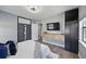 Modern bedroom with wood-look flooring, a built-in closet, a mounted TV, and stylish contemporary decor at 2301 46Th S St, St Petersburg, FL 33711