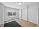 Bright bedroom with natural light, neutral carpet, and a door leading to a backyard at 2301 46Th S St, St Petersburg, FL 33711