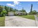 Charming single-story home with a long driveway, well-manicured lawn, and mature trees, offering great curb appeal at 2301 46Th S St, St Petersburg, FL 33711