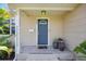 Charming front entrance with a blue door, potted plants, and a welcoming tiled porch at 2301 46Th S St, St Petersburg, FL 33711