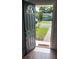 Inviting front entrance with black door, sidelight, and view of the landscaped front yard at 2301 46Th S St, St Petersburg, FL 33711