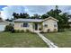 Charming single-story home with well-manicured lawn and stone walkway leading to a welcoming front door at 2301 46Th S St, St Petersburg, FL 33711