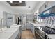 Modern kitchen featuring stainless steel appliances, stylish cabinetry, and wood-look floors at 2301 46Th S St, St Petersburg, FL 33711