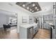 Bright kitchen featuring gray cabinets, a farmhouse sink, stainless steel appliances, and a view to the living room at 2301 46Th S St, St Petersburg, FL 33711