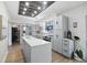 Bright kitchen featuring gray cabinets, an island with white countertop, and a unique wood ceiling design at 2301 46Th S St, St Petersburg, FL 33711