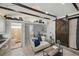 Cozy living room with wooden beams, a sliding barn door, and a modern aesthetic at 2301 46Th S St, St Petersburg, FL 33711