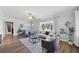 Bright living room featuring wood floors, a ceiling fan, and large windows providing natural light at 2301 46Th S St, St Petersburg, FL 33711