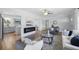 Open-concept living room showcasing a fireplace, modern decor, and seamless flow into the kitchen area at 2301 46Th S St, St Petersburg, FL 33711
