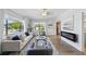Bright living room with large windows, hardwood floors, fireplace, and neutral decor for a comfortable atmosphere at 2301 46Th S St, St Petersburg, FL 33711
