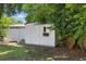 Backyard shed surrounded by lush greenery, offering extra storage space at 2301 46Th S St, St Petersburg, FL 33711