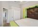 Bedroom showcasing a bed with a unique headboard design and access to a hallway and closet, maximizing space at 2967 Bayshore Pointe Dr, Tampa, FL 33611