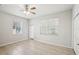 Bright bedroom features tile flooring, two windows, and a closet at 2967 Bayshore Pointe Dr, Tampa, FL 33611