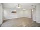 Spacious living room features stylish flooring, ceiling fan, and neutral paint at 2967 Bayshore Pointe Dr, Tampa, FL 33611