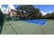 Well-maintained blue and green community tennis court surrounded by mature trees at 2967 Bayshore Pointe Dr, Tampa, FL 33611